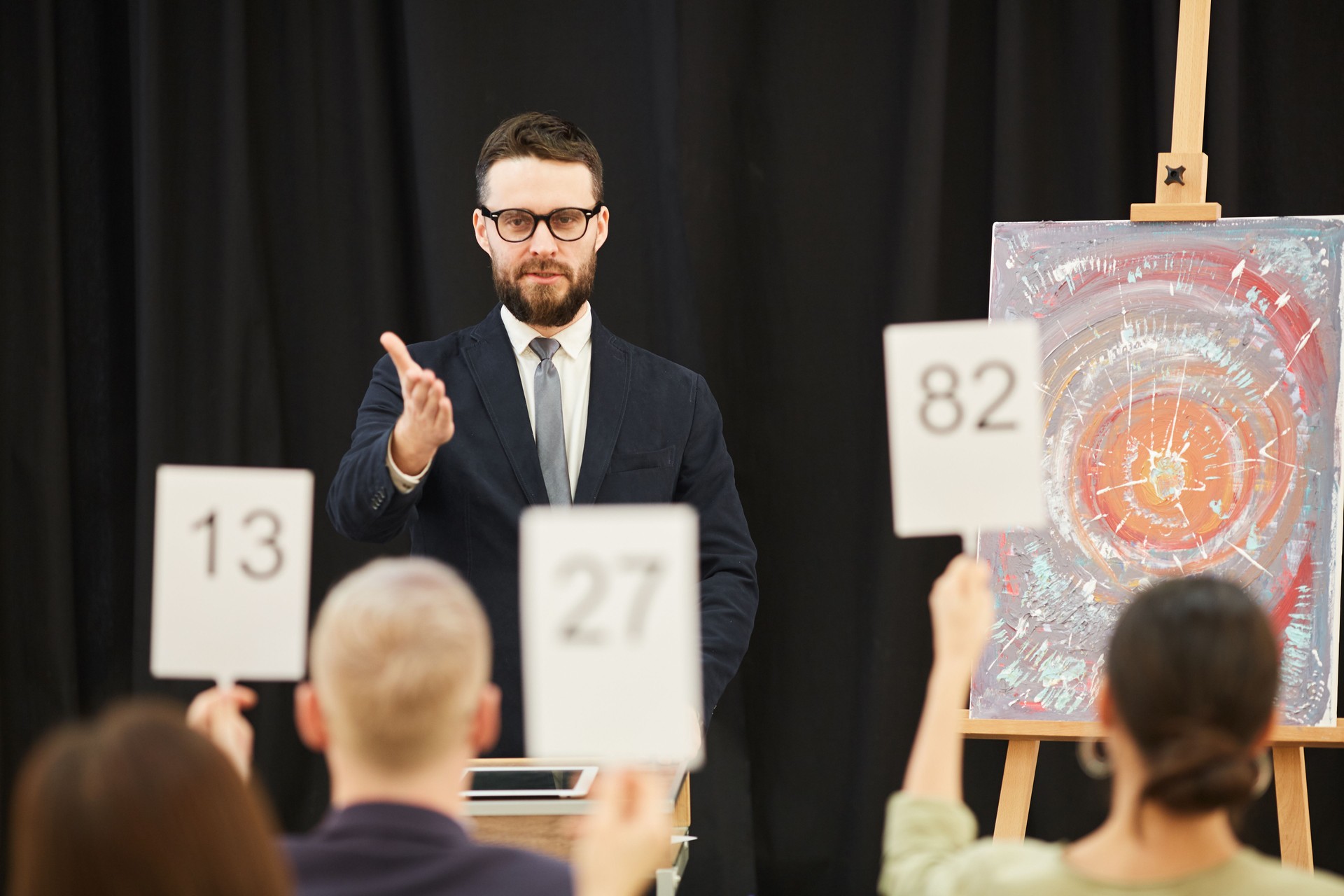 Businessman suggesting lot at auction