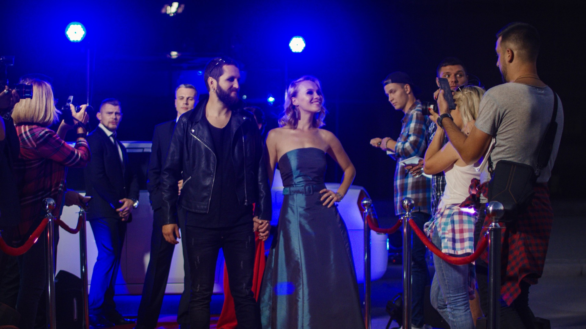 Artists on red carpet with fans and photographers